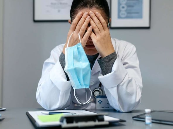 female-doctor-with-pandemic-fatigue-covering-her-face-picture-id1293426050-2
