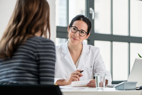 female-european-adult-doctor-consultation-with-patient-laptop-on-the-desk-print