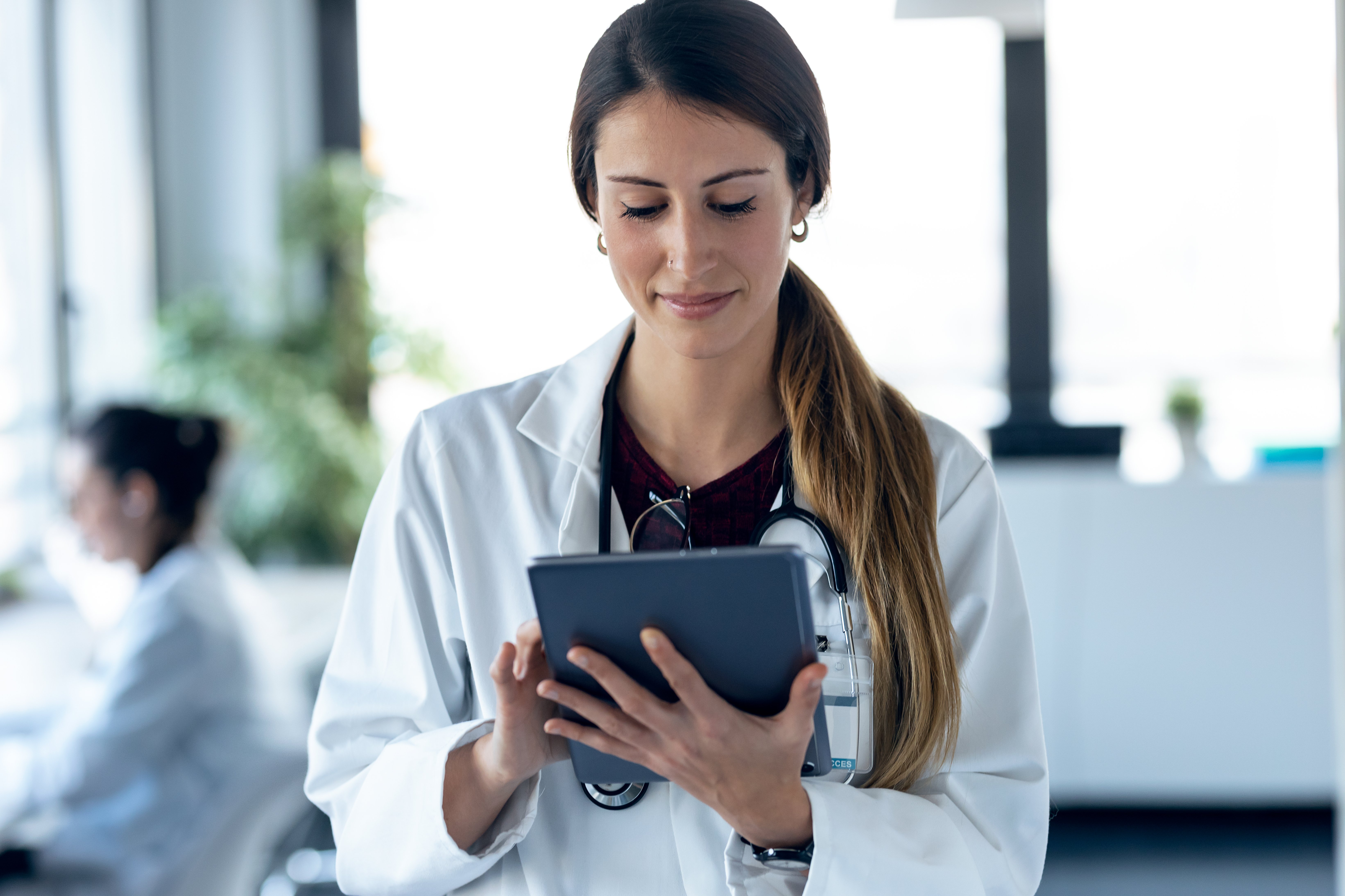 female-european-adult-doctor-hospital-using-tablet-and-wearing-stethoscope-web