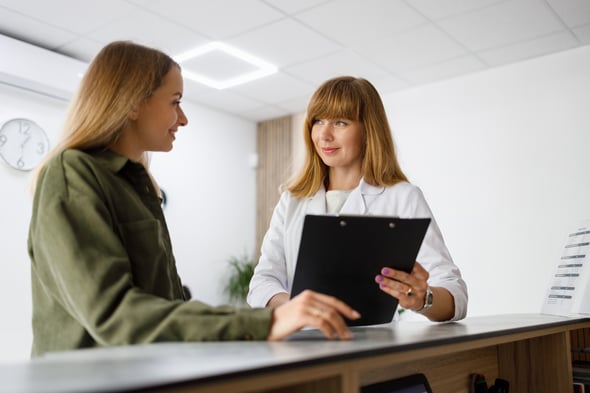 female-european-adult-doctor-reception-talking-with-patient-print-1